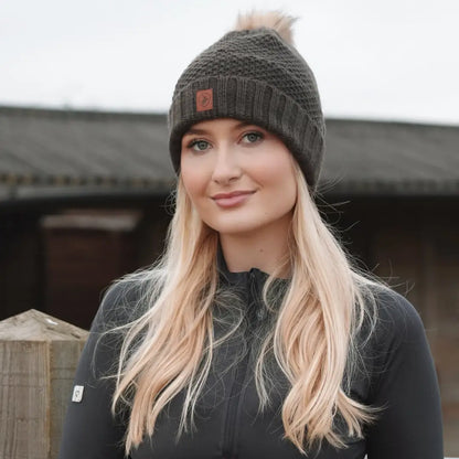 Woman in dark gray ladies knitted hat and sweater with long blonde hair