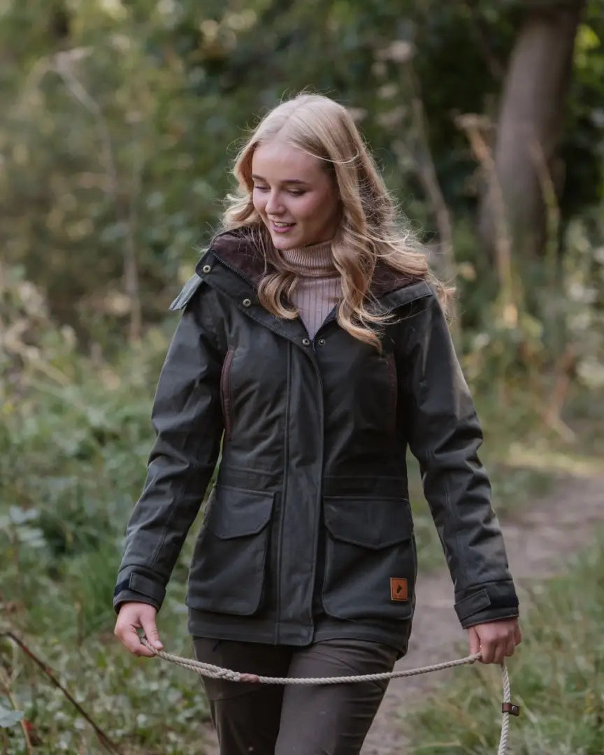 Forest ladies marsh jacket with hood, front pockets, and light pink turtleneck