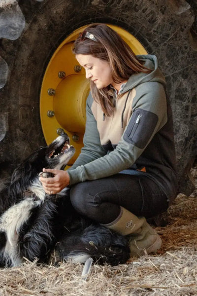 Woman petting a dog wearing New Forest Ladies Outdoor Stretch Trousers in the forest
