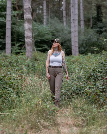 Woman in forest ladies outdoor stretch trousers enjoying nature outdoors
