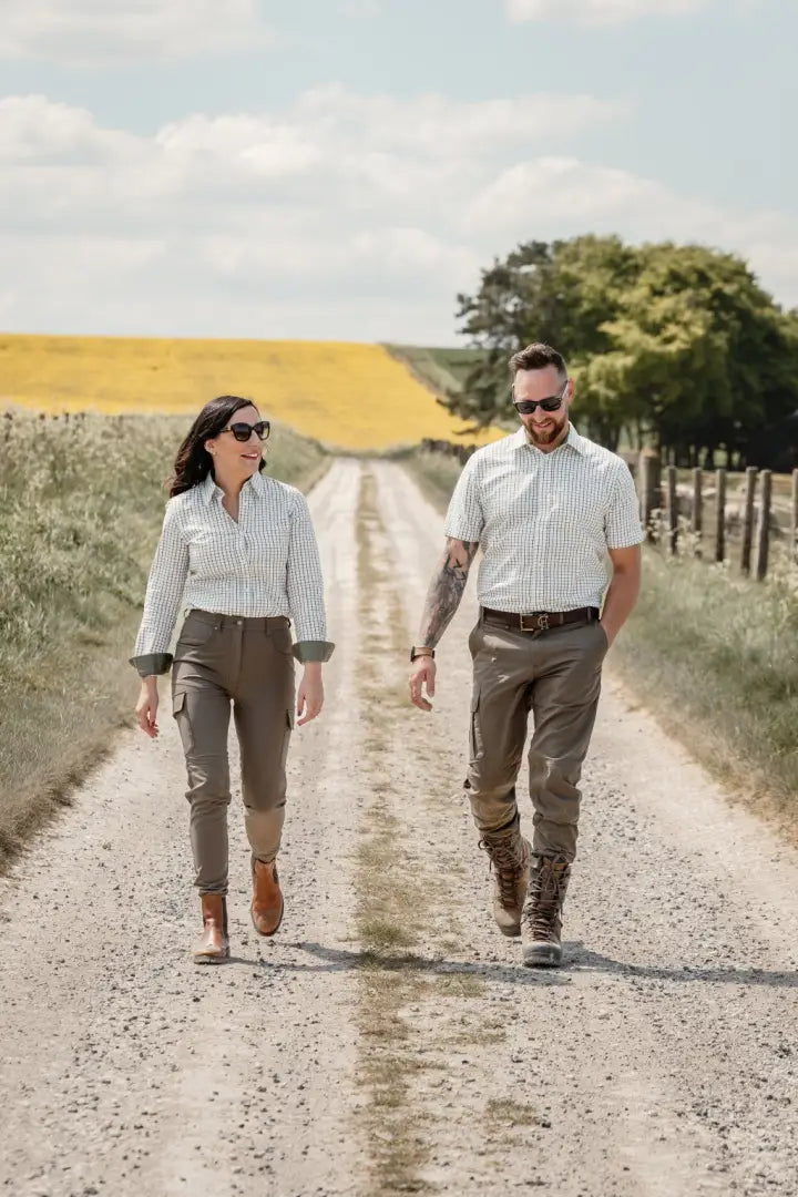 Couple wearing New Forest Ladies Premium Tattersall Shirt walking on a dirt road in countryside