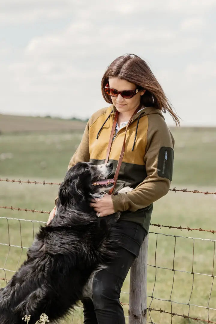 Woman hugging a dog in the New Forest Ladies Raptor Hoodie, perfect forest raptor style