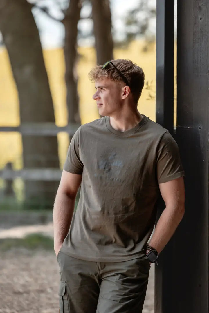 Man wearing New Forest Logo T-Shirt with forest clothing graphic and cargo pants