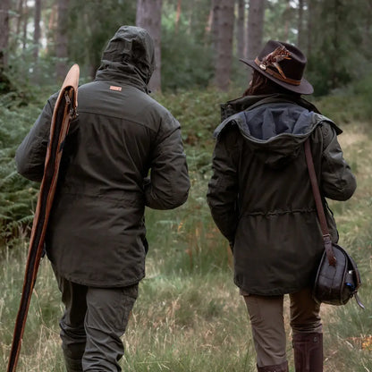 Two people in hunting attire wearing the New Forest Marsh Jacket in outdoor setting