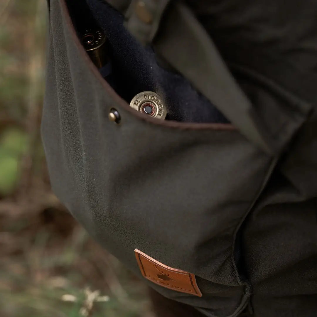 Green canvas hunting bag with shotgun shells for the New Forest Marsh Jacket in forest marsh style