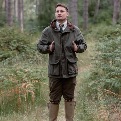 Man in outdoor hunting attire wearing the New Forest Marsh Jacket in the forest
