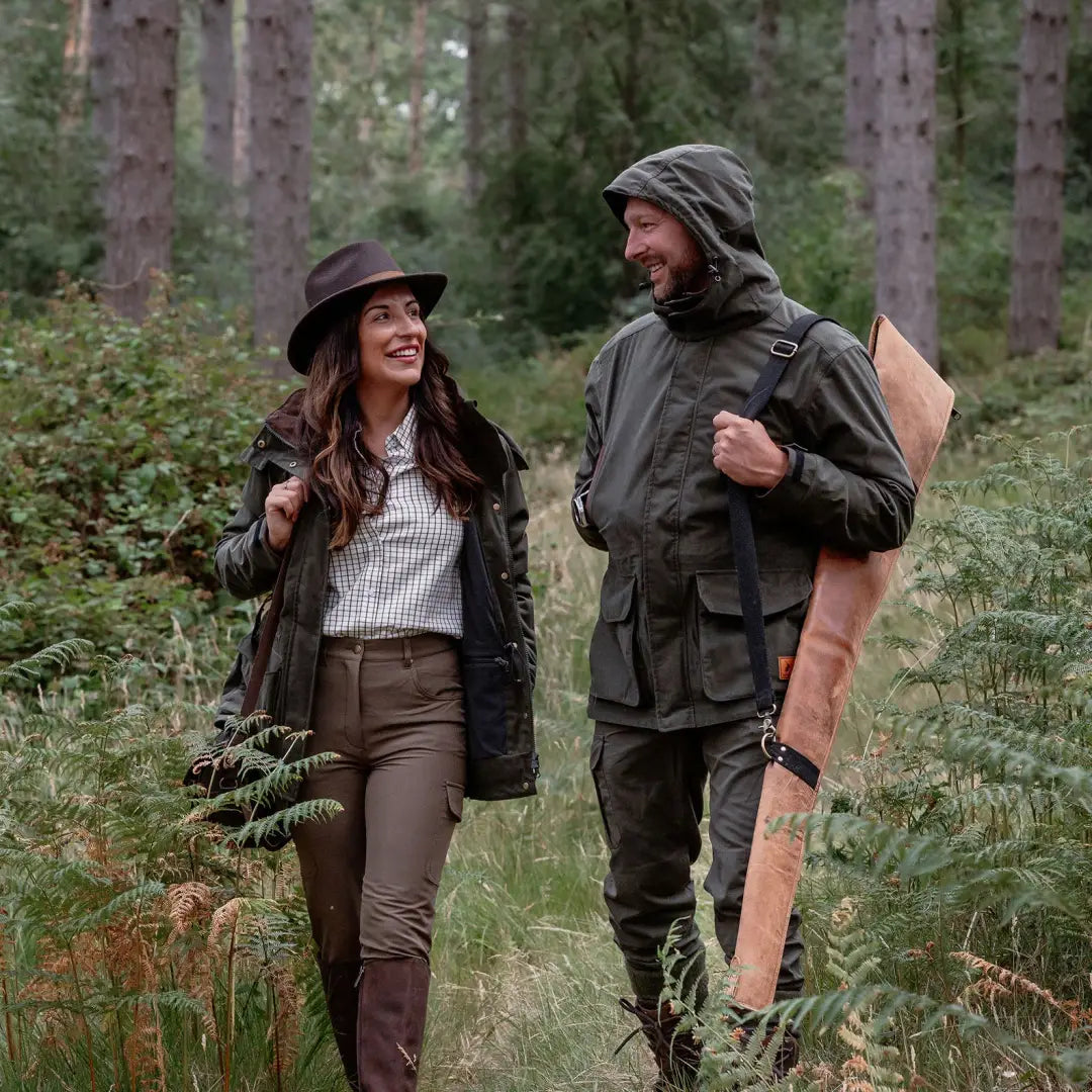 Couple in outdoor hunting gear wearing New Forest Marsh Jacket in the forest
