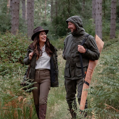 Couple in outdoor hunting gear wearing New Forest Marsh Jacket in the forest