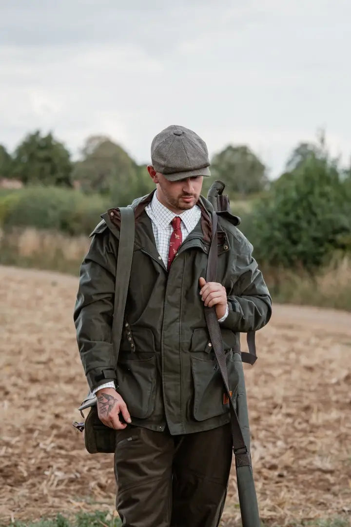 Man in green forest marsh jacket with rifle, perfect for outdoor hunting trips