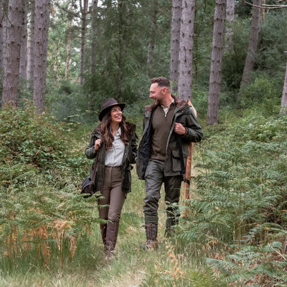 Couple hiking in the woods wearing the New Forest Marsh Jacket for outdoor adventures