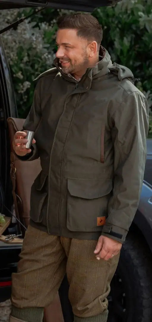 Man wearing forest maverick waterproof jacket with pockets, perfect for outdoor hunting