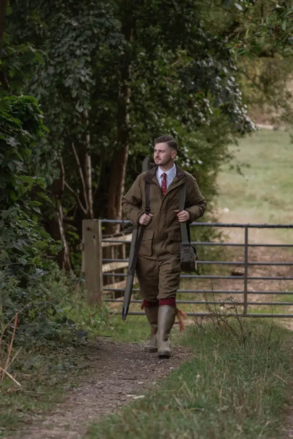 Man in hunting gear wearing New Forest Maverick Waterproof Tweed Breeks with shotgun