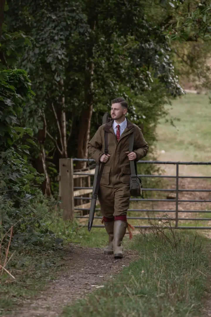 Man in hunting gear wearing New Forest Maverick Waterproof Tweed Breeks with shotgun