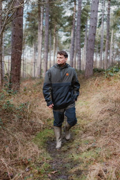 Man in outdoor gear walking through woods wearing Forest Nightjar Trousers