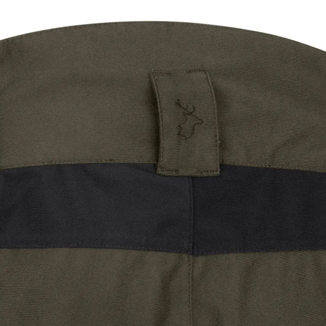 Green and black fabric featuring a deer logo on New Forest Nightjar Trousers