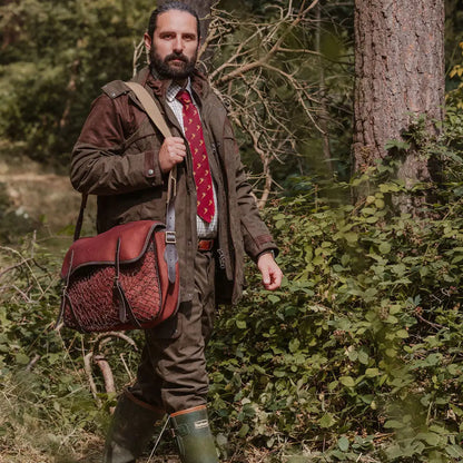 Bearded man outdoors with New Forest Performance Field Coat and leather satchel
