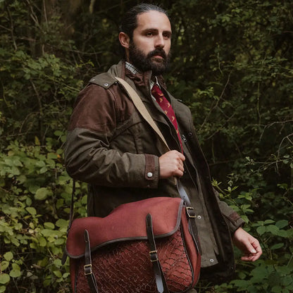 Bearded man in brown jacket and red tie with leather satchel, showcasing Forest Performance Field Coat