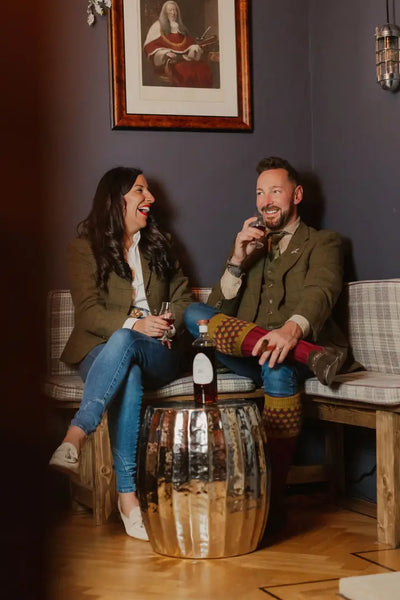Two people enjoying drinks while wearing the stylish Polly Tweed Blazer