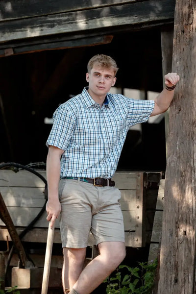 Man in plaid cotton short sleeve forest premium shirt and khaki shorts