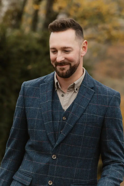 Man in a blue plaid suit showcasing the New Forest Premium wool tweed blazer