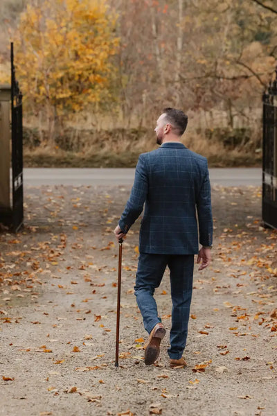 Man in blue suit and walking stick showcasing New Forest Premium Wool Tweed Trousers