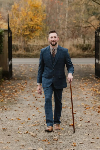 Man in blue plaid suit with walking stick, showcasing New Forest Premium Wool Tweed Trousers