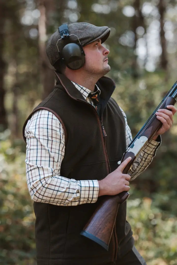 Man in hunting attire with shotgun wearing New Forest Premium Tattersall Shirt