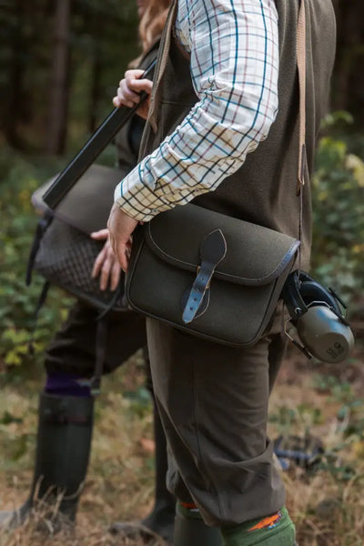 Dark green hunting bag with leather strap over shoulder, perfect with Forest Premium Tattersall Shirt