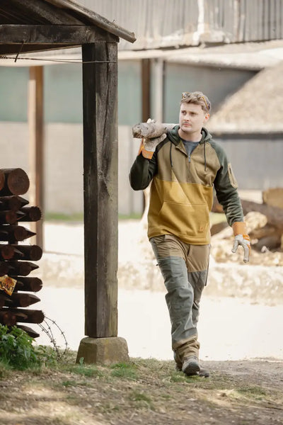 Man carrying firewood in New Forest Raptor Hoodie, a cool forest raptor hoodie style