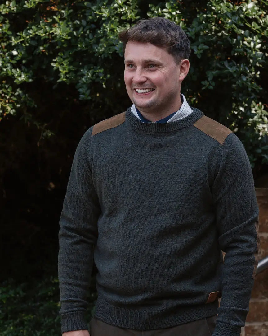 Men’s forest raven crew neck jumper with dark green fabric and brown shoulder patches