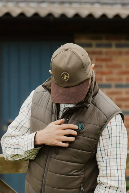 Brown quilted vest paired with New Forest Stag Baseball Cap for a stylish look