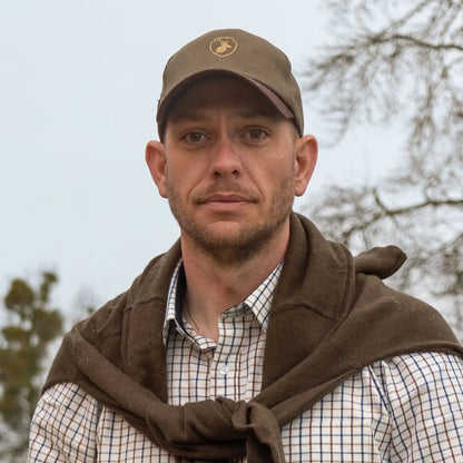 Man in a baseball cap and checkered shirt models the New Forest Stag Baseball Cap