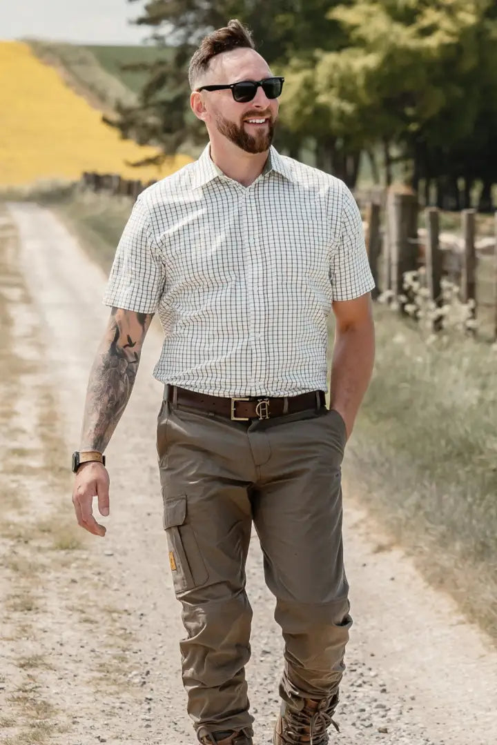 Man wearing New Forest Trail Trousers in a forest trail setting perfect for outdoor adventures