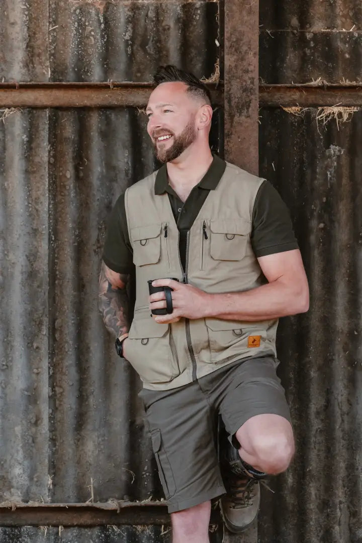 Man in khaki vest and shorts showing New Forest V-Neck Explorer Gilet, perfect for outdoor adventures