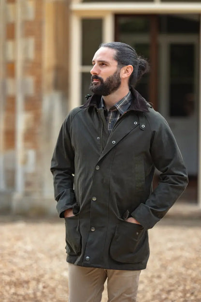 Men’s dark green Forest Woodsman Wax Jacket with corduroy collar for outdoor style