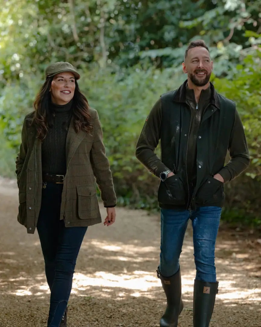 Two people in smart casual outdoor clothing wearing the New Forest Zip Neck Jumper on a path