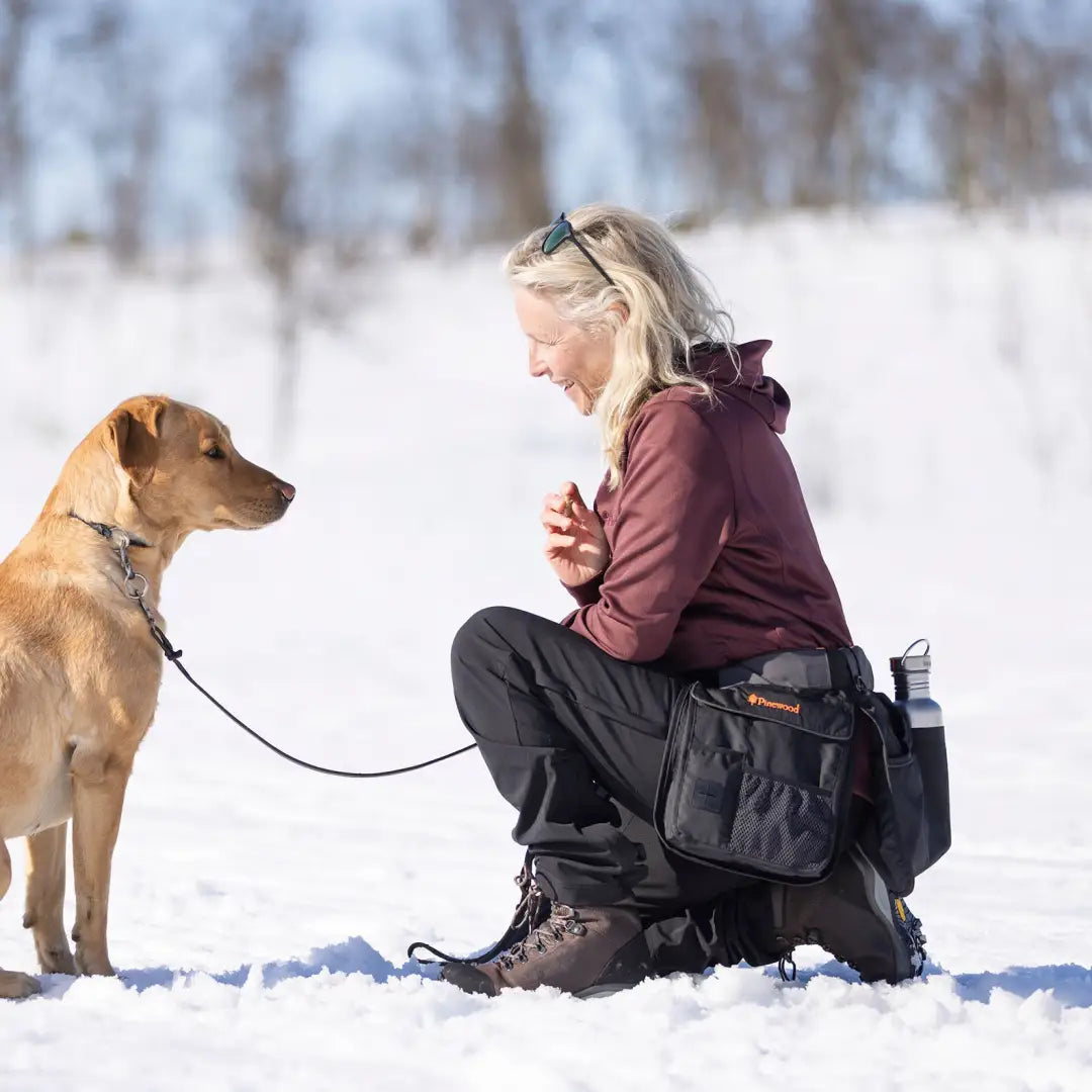 Woman training a dog while using Pinewood Dog Sports Utility Belt for dog sports