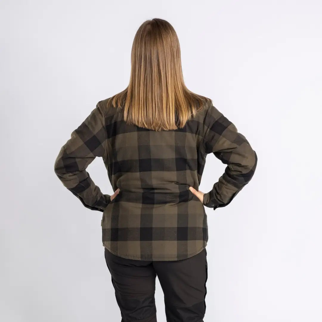 Person in plaid flannel shirt and dark pants, ideal for country clothing and hunting