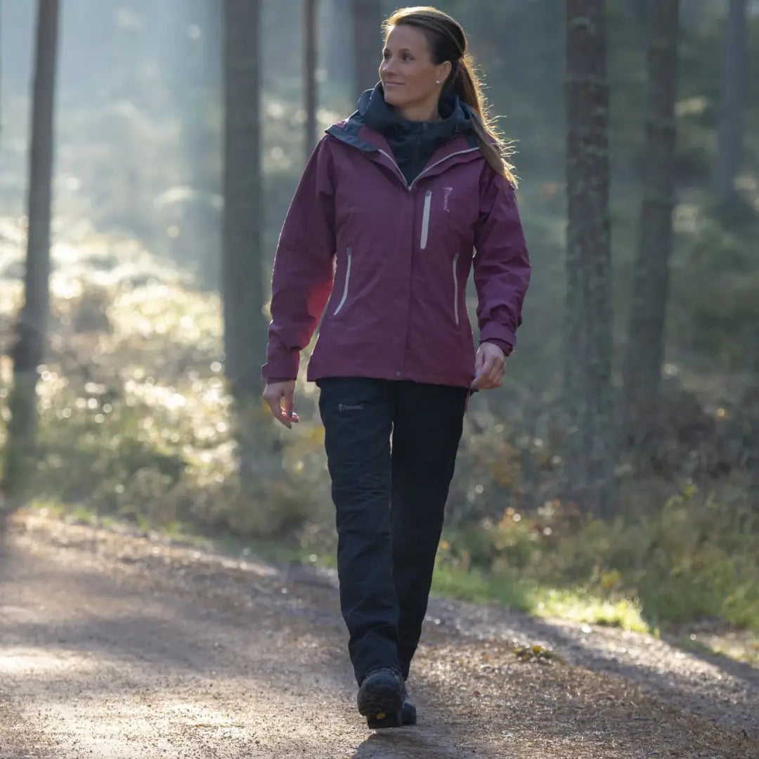 Woman in purple outdoor jacket walking a path in Pinewood Ladies Caribou TC Trousers
