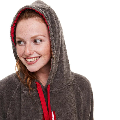 Smiling woman in a gray hooded sweatshirt with red lining, showcasing a towelling change robe
