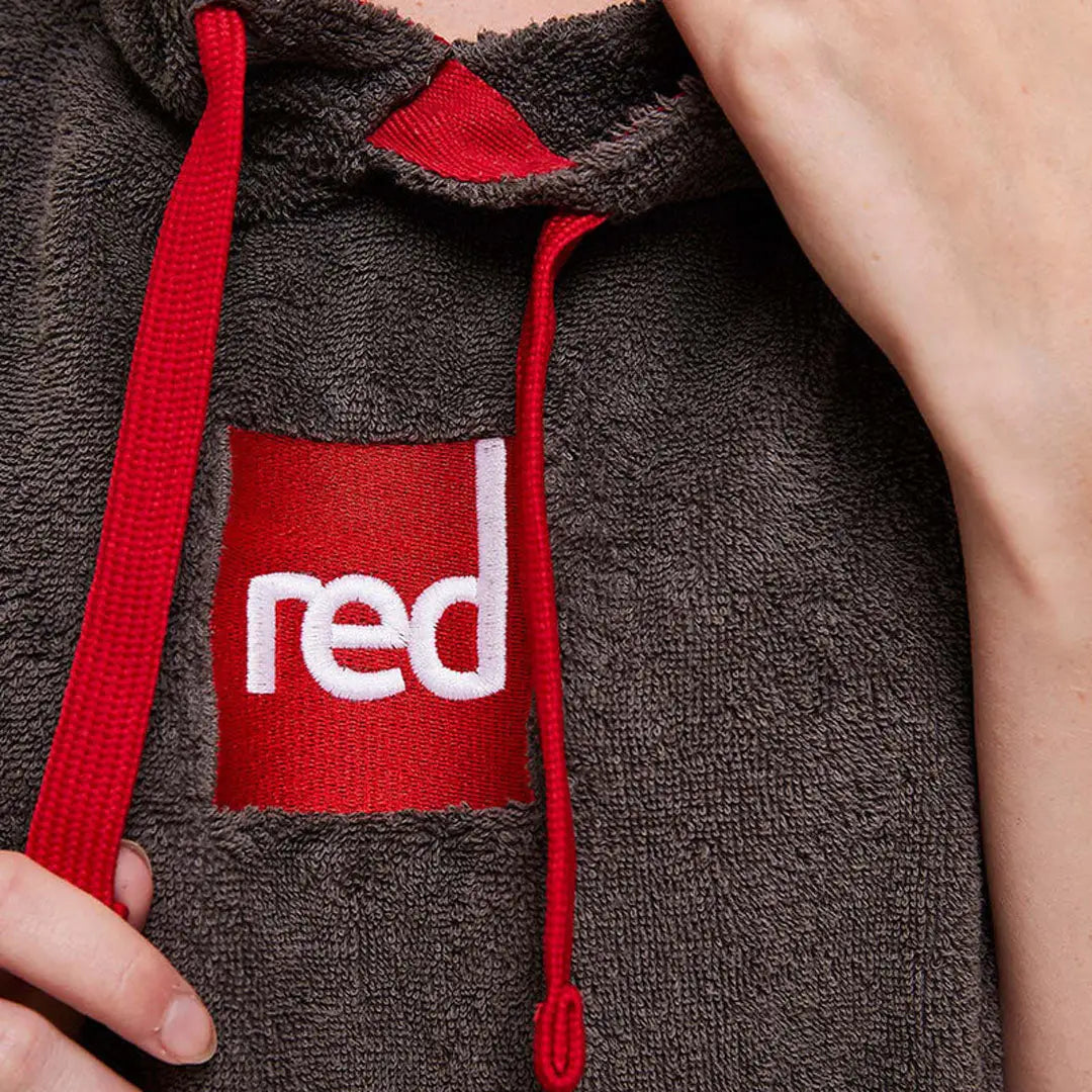 Gray towelling change robe with red accents and bold red patch saying red