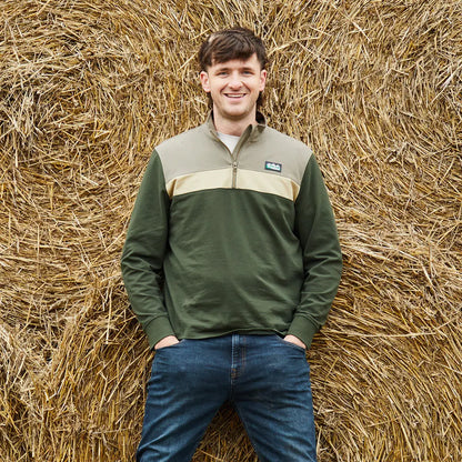 Man in green and tan pullover showcasing Ridgeline Back Slider Rugby Top for country clothing