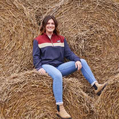 Woman in casual clothing on hay bale wearing Ridgeline Back Slider Rugby Top, ideal country clothing