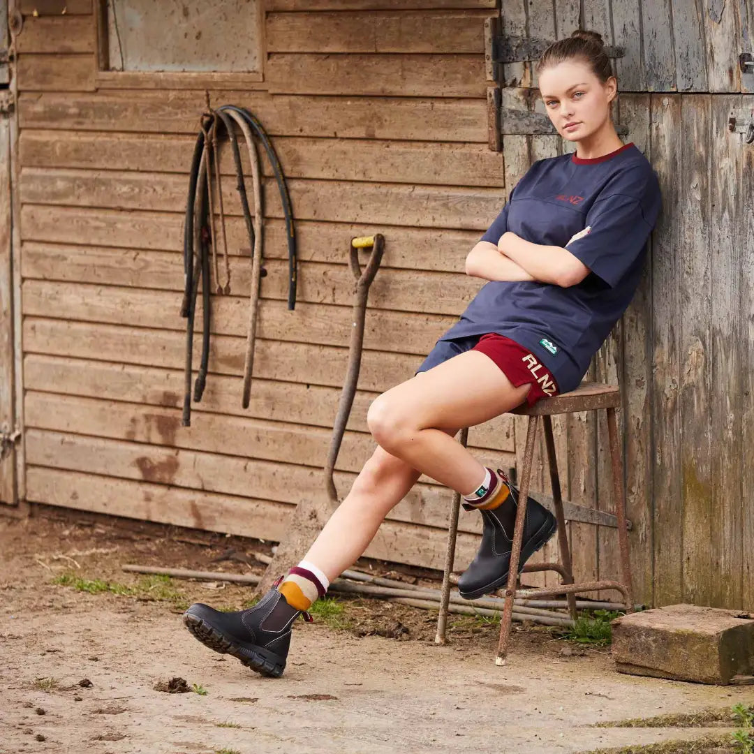 Person chillin on a chair outside a rustic building in Ridgeline Hose Down T-Shirt
