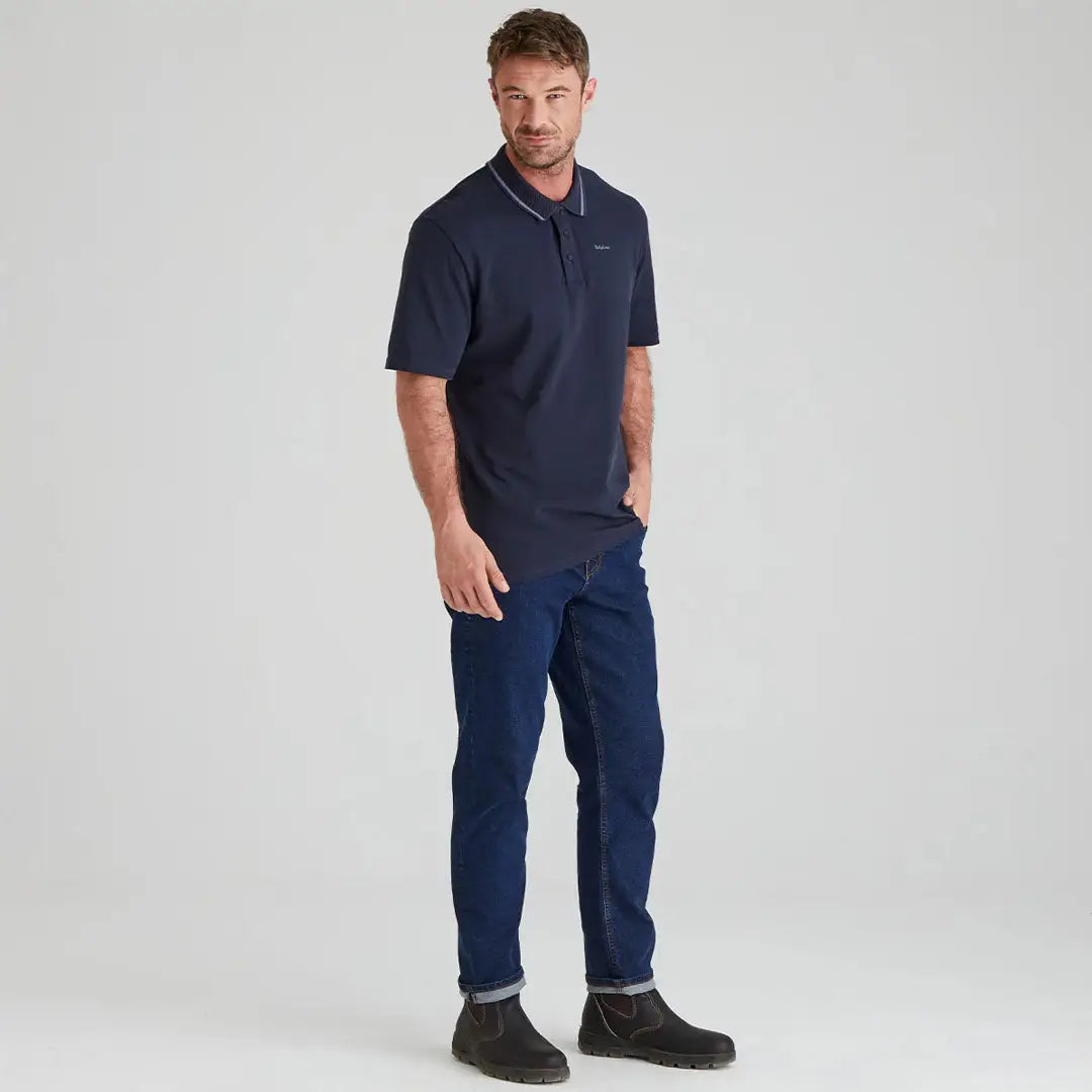 Man wearing Ridgeline Kilworth Polo Top in navy with jeans for a casual look