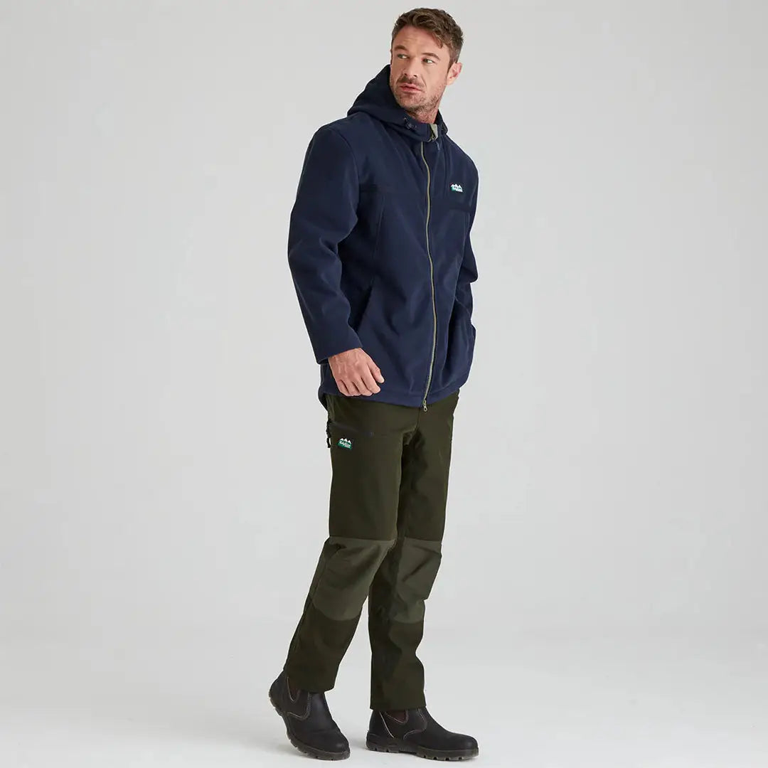 Man in navy Ridgeline Kodiak Fleece Jacket and green pants, perfect for highly technical southern adventures