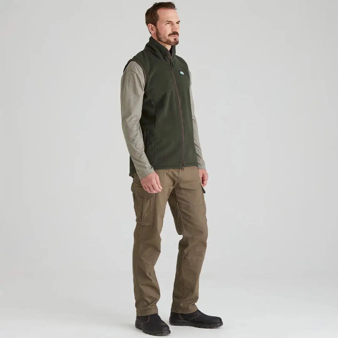 Man wearing Ridgeline Kodiak Gilet in olive green with cargo pants comfortable outdoor look