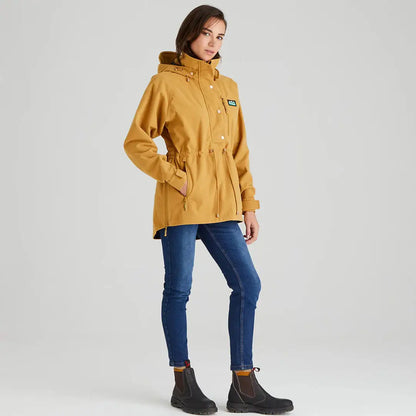 Woman in mustard Ridgeline Ladies Monsoon Nordic Smock with blue jeans and black boots