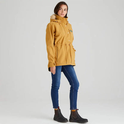 Woman in a mustard Ridgeline Ladies Monsoon Nordic Smock with blue jeans and black boots