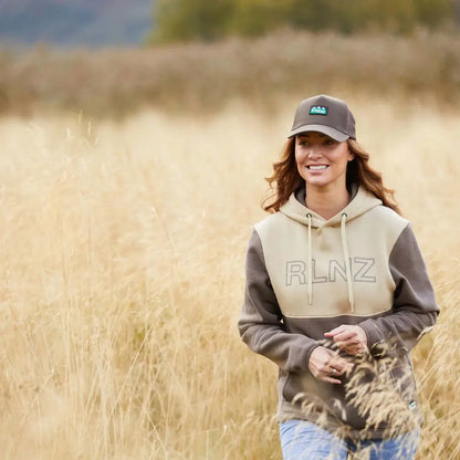 Woman in Ridgeline Ladies South Island Hoodie with two-tone hoodie and baseball cap